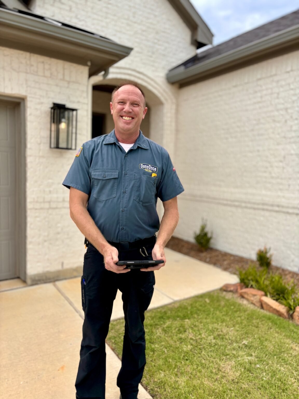 Scott standing in front of customer's home